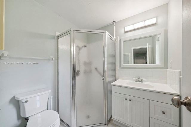 full bathroom featuring toilet, a shower stall, tasteful backsplash, and vanity