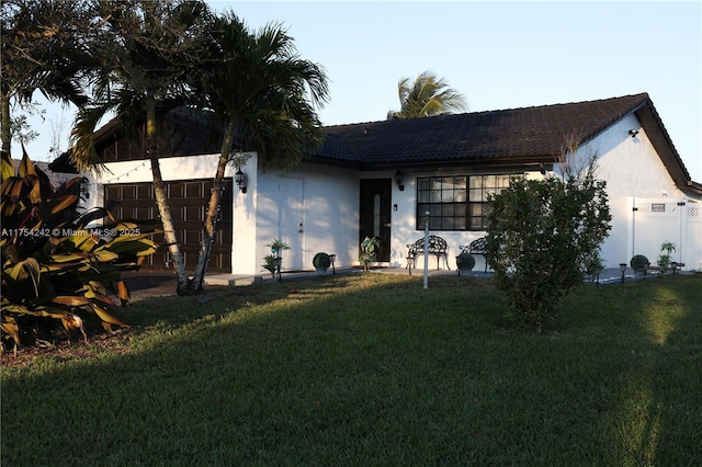 view of front facade with a front lawn and stucco siding