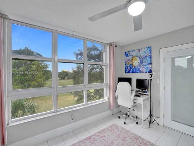 home office featuring ceiling fan, baseboards, and light tile patterned floors