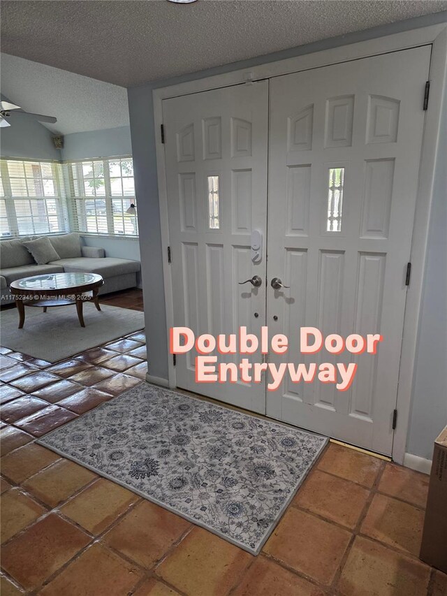 1350 S Fieldlark Ln, Homestead, FL 33035 - entrance foyer with a textured ceiling, ceiling fan, and tile patterned flooring