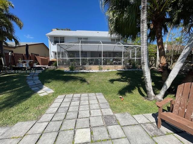 1350 S Fieldlark Ln, Homestead, FL 33035 - back of house featuring a lawn, a patio, and a lanai
