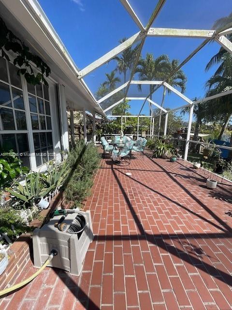 1350 S Fieldlark Ln, Homestead, FL 33035 - view of patio / terrace with glass enclosure and central AC