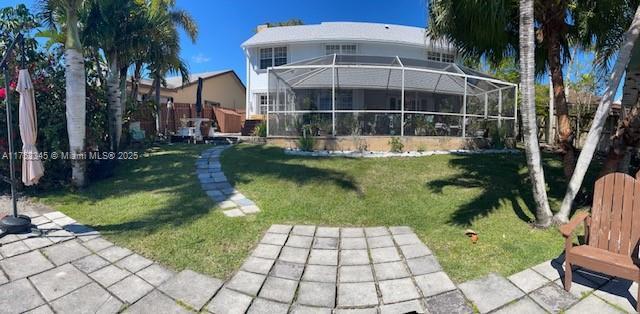 1350 S Fieldlark Ln, Homestead, FL 33035 - rear view of house with a yard and a lanai