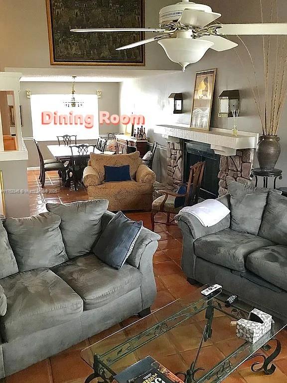 1350 S Fieldlark Ln, Homestead, FL 33035 - living room featuring a stone fireplace and tile patterned floors