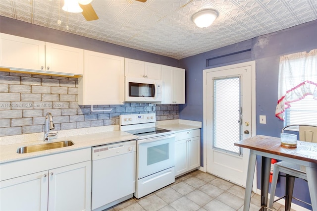 kitchen featuring white appliances, a sink, an ornate ceiling, and decorative backsplash