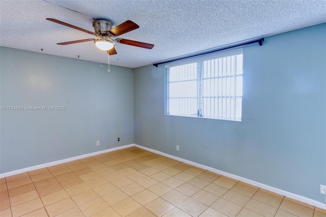 spare room featuring ceiling fan, a textured ceiling, and baseboards