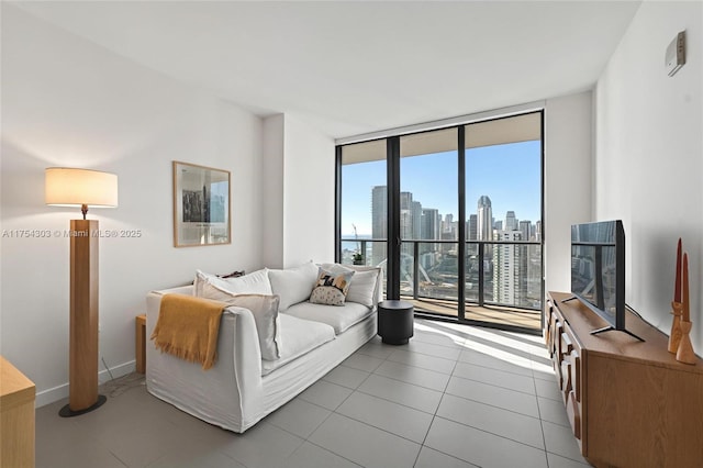 tiled living area with baseboards and floor to ceiling windows