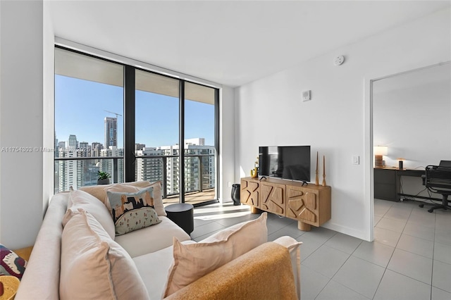 living area featuring expansive windows, tile patterned flooring, and baseboards