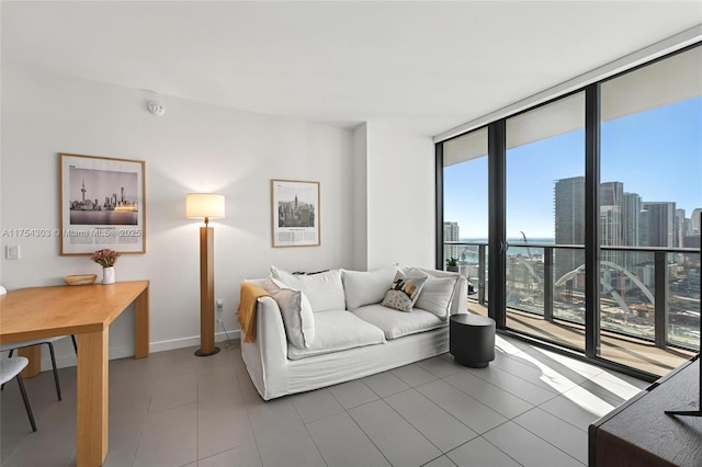 living area with tile patterned flooring, baseboards, floor to ceiling windows, and a city view