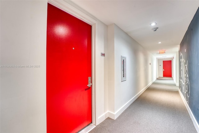 hallway featuring recessed lighting, carpet, and baseboards