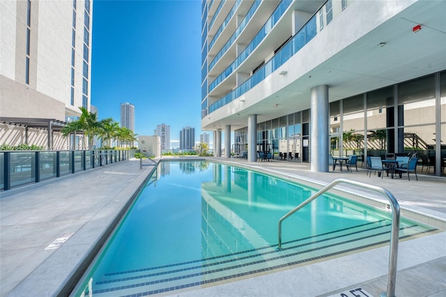 view of swimming pool with a view of city