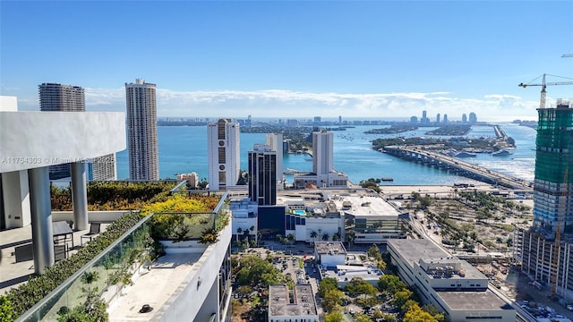 birds eye view of property with a water view and a view of city