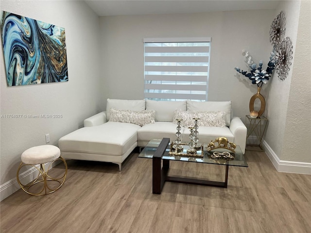 living room featuring light wood-style flooring and baseboards