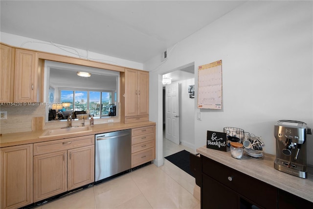 kitchen featuring a sink, light countertops, dishwasher, and light tile patterned flooring