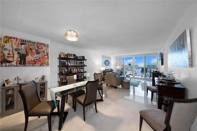 dining room with floor to ceiling windows and a textured ceiling