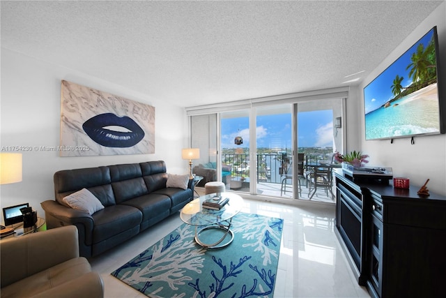 living room featuring a textured ceiling and floor to ceiling windows