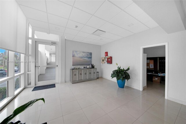 521 N Riverside Dr Unit 808, Pompano Beach, FL 33062 - tiled living area with baseboards and a drop ceiling