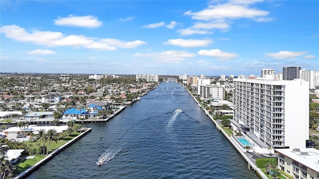 birds eye view of property with a water view and a city view