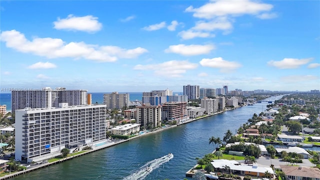 drone / aerial view featuring a view of city and a water view