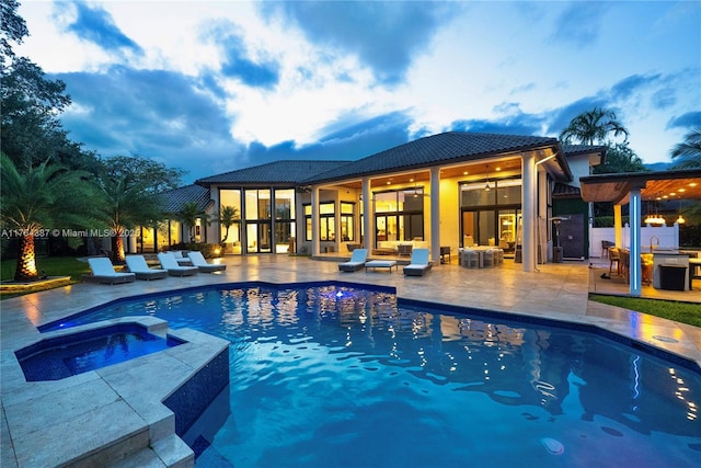 2980 Windmill Ranch Rd, Weston, FL 33331 - pool at dusk with a patio and a pool with connected hot tub