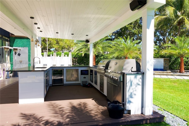 view of patio with an outdoor kitchen and a sink