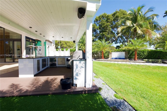 exterior space with fence and exterior kitchen