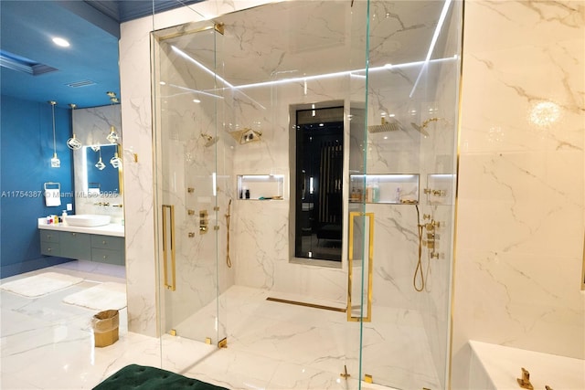 full bath with marble finish floor, vanity, a marble finish shower, and stone wall