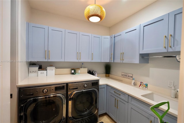 washroom featuring washer and clothes dryer and cabinet space