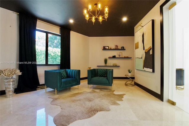 sitting room featuring a notable chandelier and baseboards