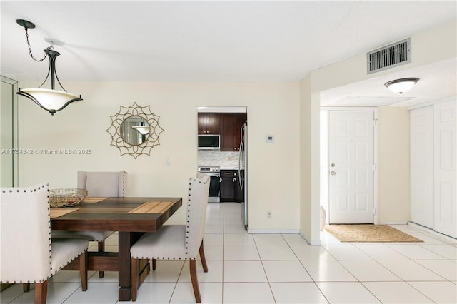 dining space featuring visible vents, baseboards, and light tile patterned floors