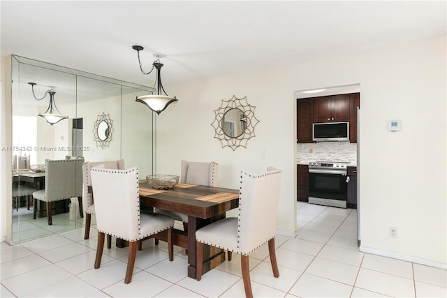 dining area with baseboards and light tile patterned floors