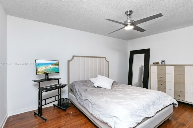 bedroom with ceiling fan, a textured ceiling, baseboards, and wood finished floors