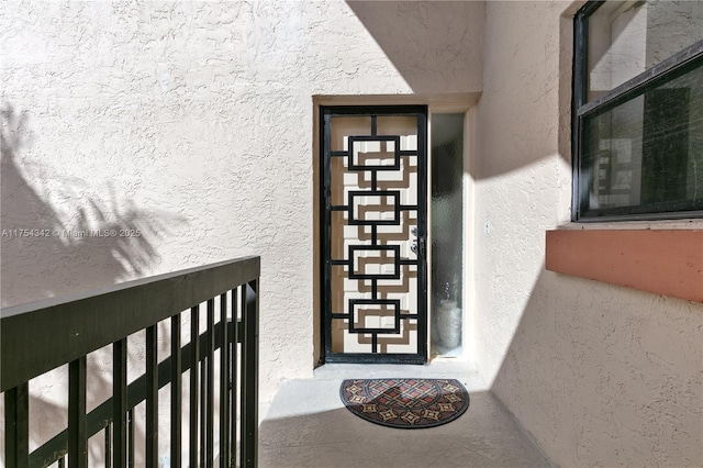 property entrance featuring stucco siding