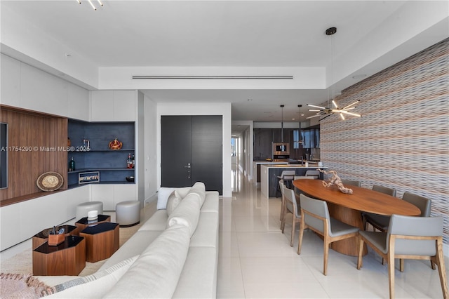 living room with light tile patterned floors and an accent wall