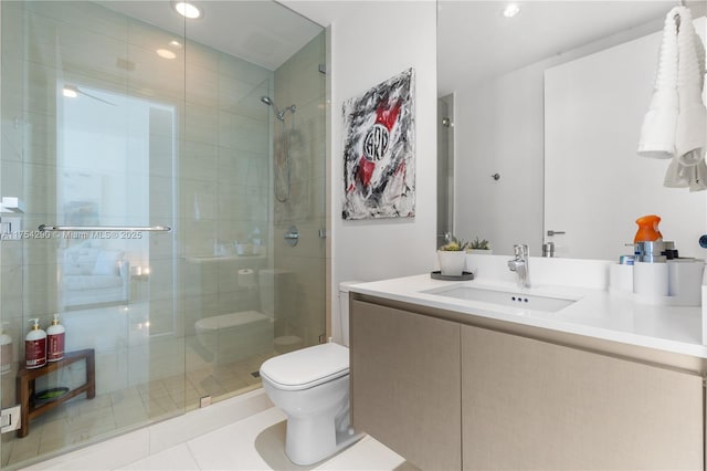 bathroom featuring vanity, a shower stall, and toilet