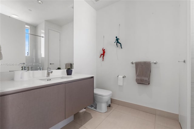 full bath with baseboards, vanity, toilet, and tile patterned floors