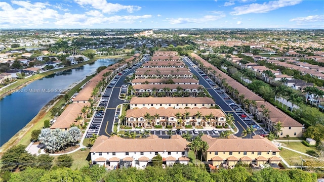 drone / aerial view with a water view and a residential view