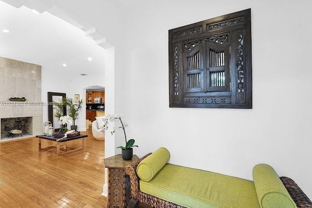 interior space featuring recessed lighting, a fireplace, and wood finished floors