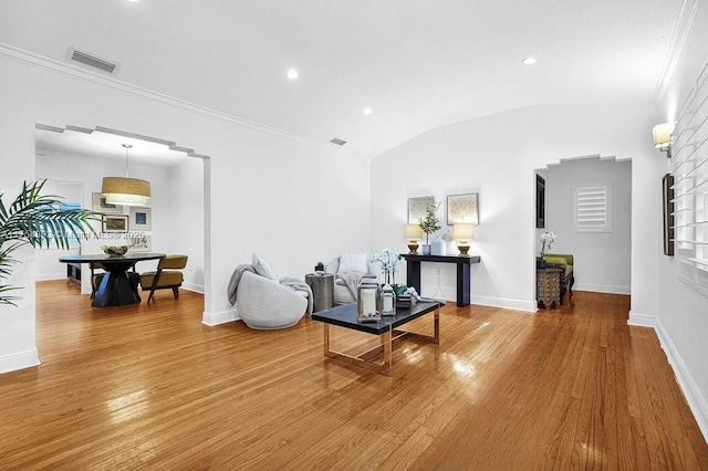 living area featuring wood-type flooring, vaulted ceiling, and baseboards