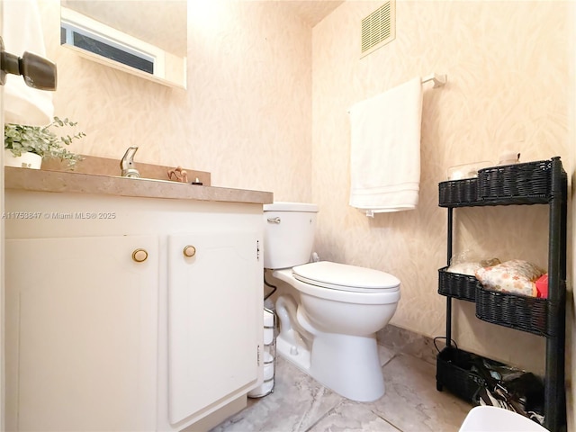 bathroom featuring visible vents, vanity, and toilet