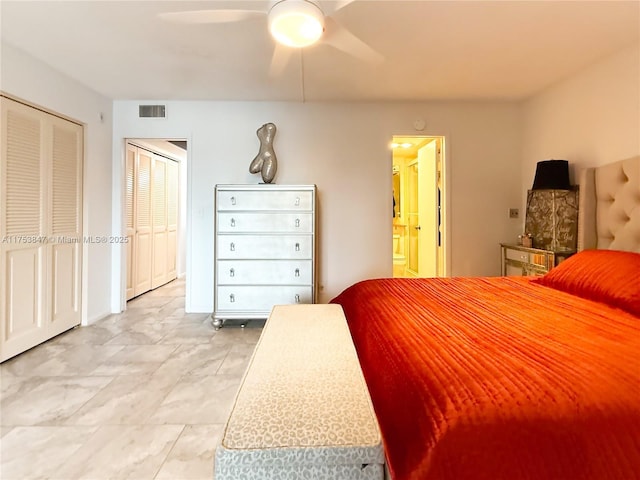 bedroom with ensuite bath, visible vents, and ceiling fan