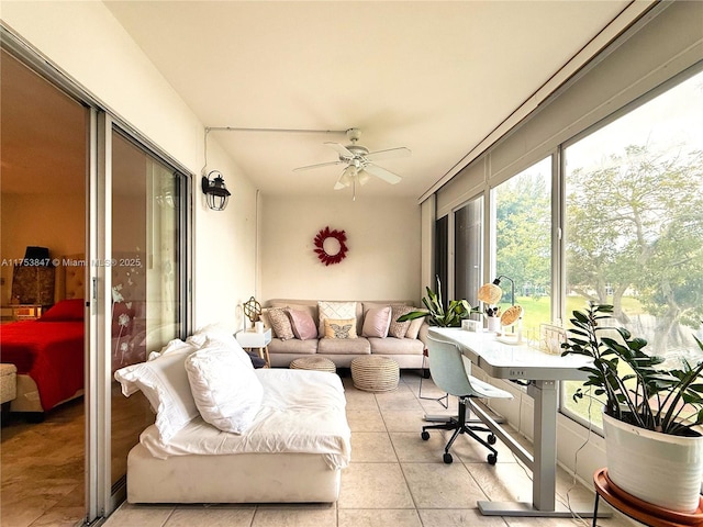 sunroom featuring a ceiling fan