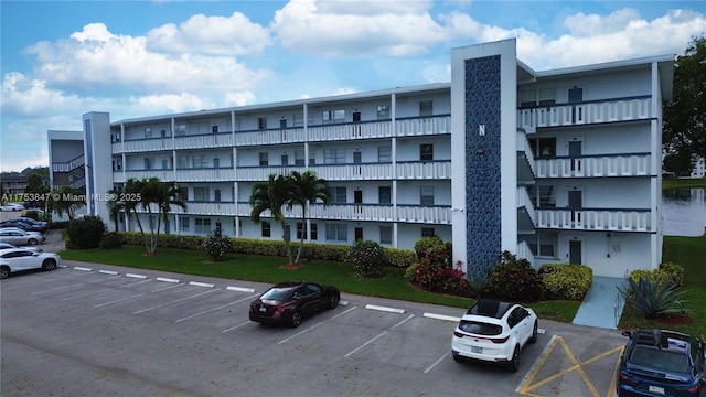 view of building exterior featuring uncovered parking