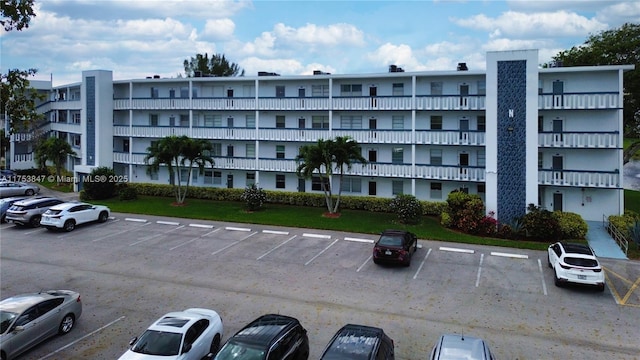 view of building exterior with uncovered parking