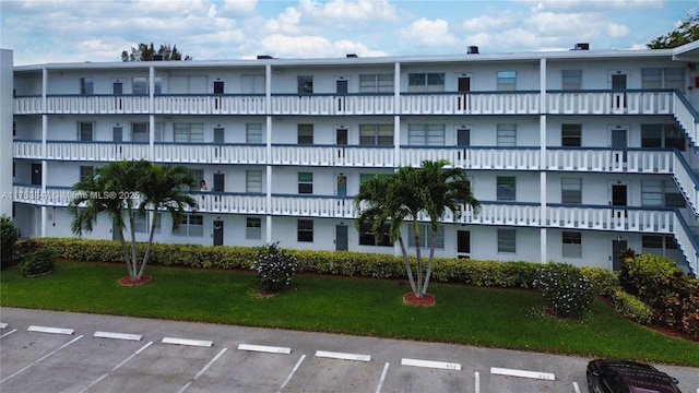 view of property featuring uncovered parking