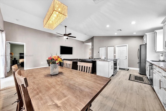 dining area featuring recessed lighting, visible vents, light wood-style floors, vaulted ceiling, and baseboards