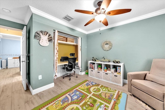 bedroom with baseboards, light wood-style flooring, visible vents, and crown molding