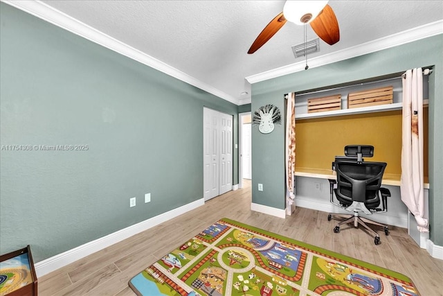 bedroom with crown molding, visible vents, a textured ceiling, wood finished floors, and baseboards