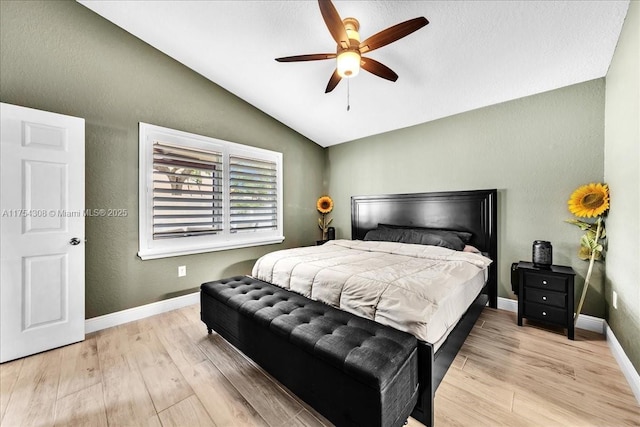 bedroom with lofted ceiling, baseboards, and light wood-style floors