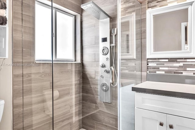 bathroom with toilet and a shower stall